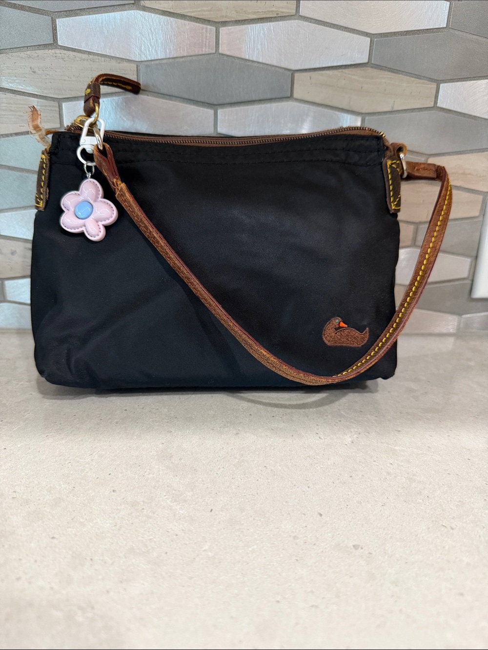 Dooney & Bourke Black Nylon Wristlet with unbranded lavender flower charm Charm
